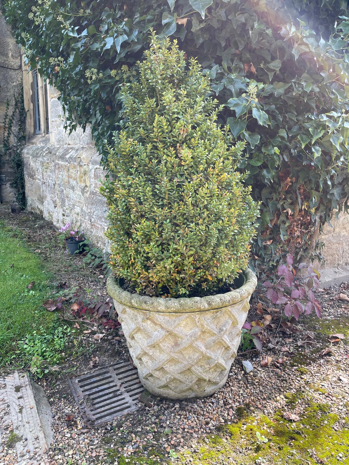 A set of four reconstituted stone garden vases